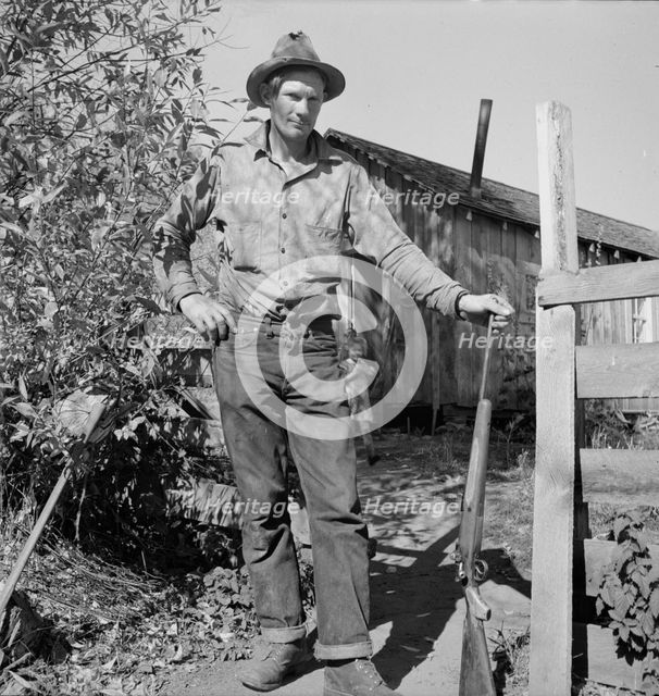 Roy Carlock, member of Ola self-help sawmill co-op, in front of his new..., Gem County, Idaho, 1939. Creator: Dorothea Lange.