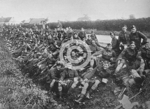 'Royal Army Medical Corps recruits take a meal in the open', 1915. Artist: Unknown.