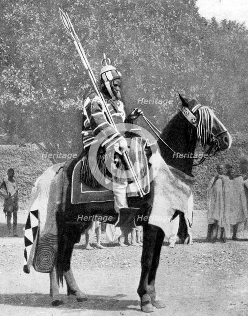 Royal bodyguard in ancient armour, northern Nigeria, 1936.Artist: Wide World Photos