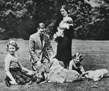 Royal family as a happy group of dog lovers, 1937. Creator: Michael Chance