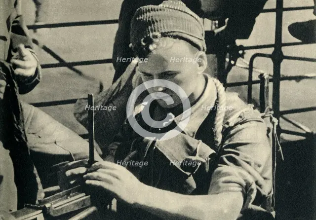 Royal Marine checking his machine gun, World War II, c1939-c1943 (1944). Creator: Unknown.