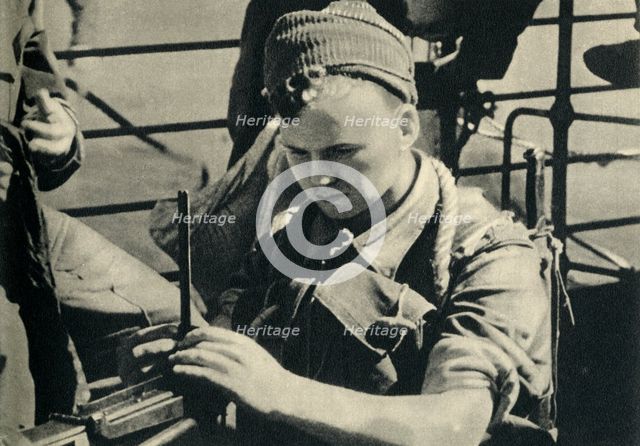 Royal Marine checking his machine gun, World War II, c1939-c1943 (1944). Creator: Unknown.