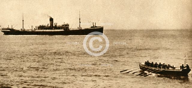 Royal navy cutter about to examine a ship's papers, First World War, 1914-1918, (1933). Creator: Unknown.