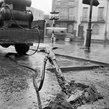 Road works with pneumatic drill, London, 1960-1965. Artist: John Gay