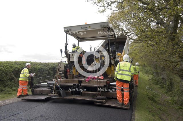 Road resurfacing work repairing potholes Artist: Unknown.