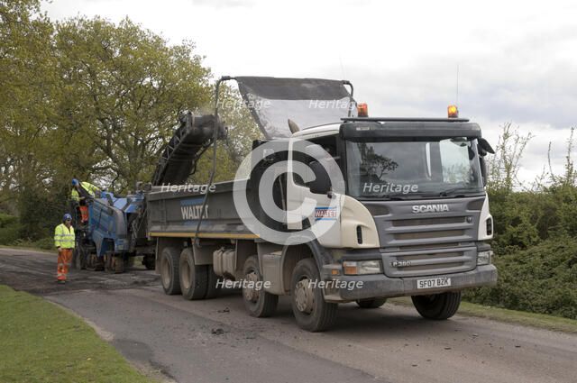 Road resurfacing work repairing potholes Artist: Unknown.