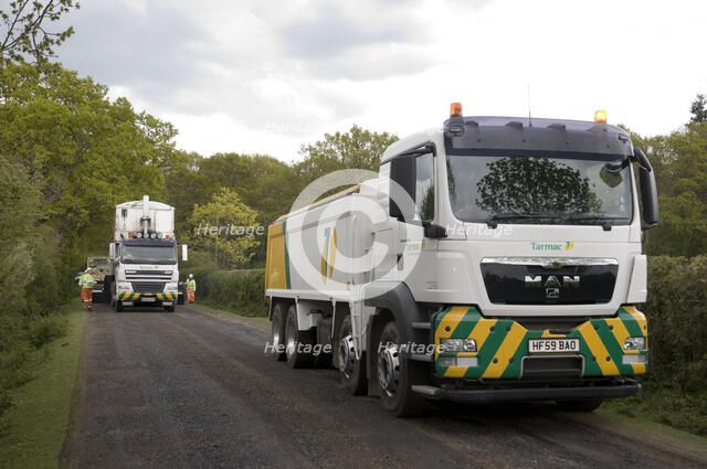 Road resurfacing work repairing potholes Artist: Unknown.