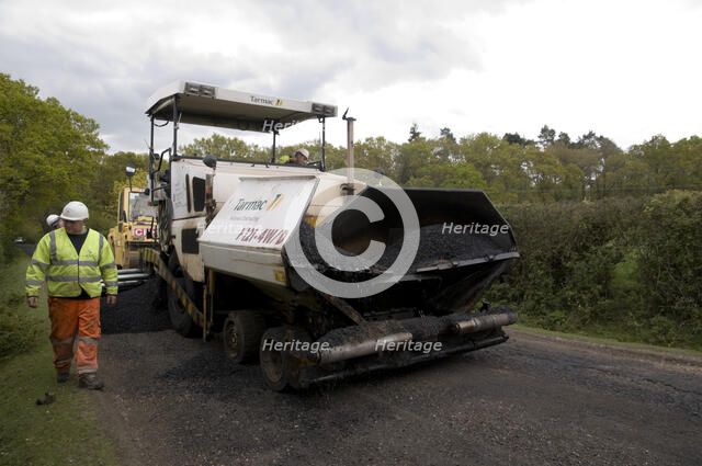 Road resurfacing work repairing potholes Artist: Unknown.
