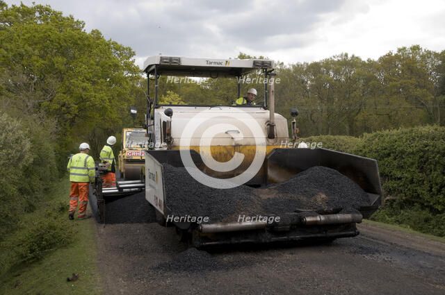 Road resurfacing work repairing potholes Artist: Unknown.