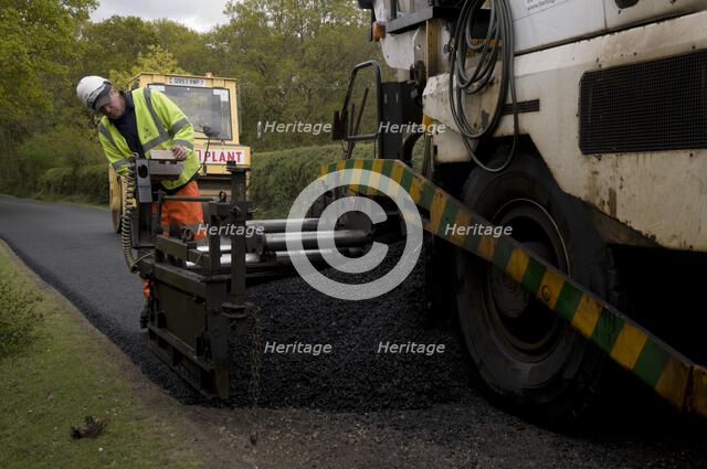 Road resurfacing work repairing potholes Artist: Unknown.