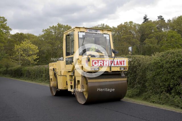 Road resurfacing work repairing potholes Artist: Unknown.