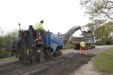 Road resurfacing work repairing potholes