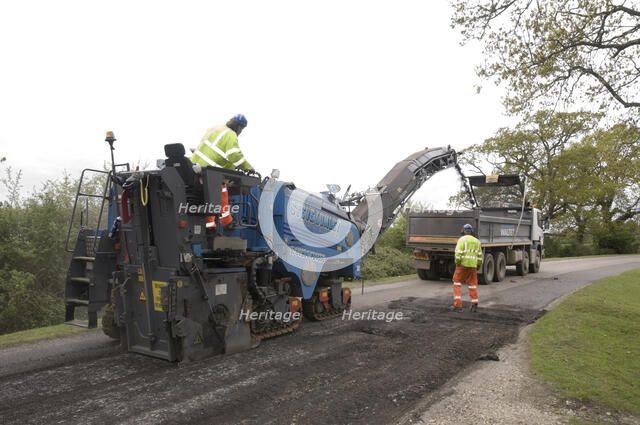 Road resurfacing work repairing potholes Artist: Unknown.
