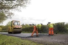 Road resurfacing work repairing potholes