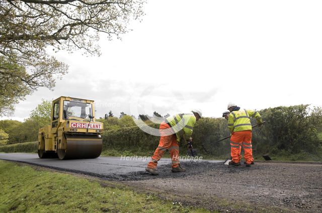 Road resurfacing work repairing potholes Artist: Unknown.