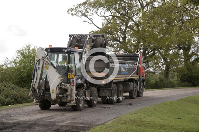 Road resurfacing work repairing potholes Artist: Unknown.