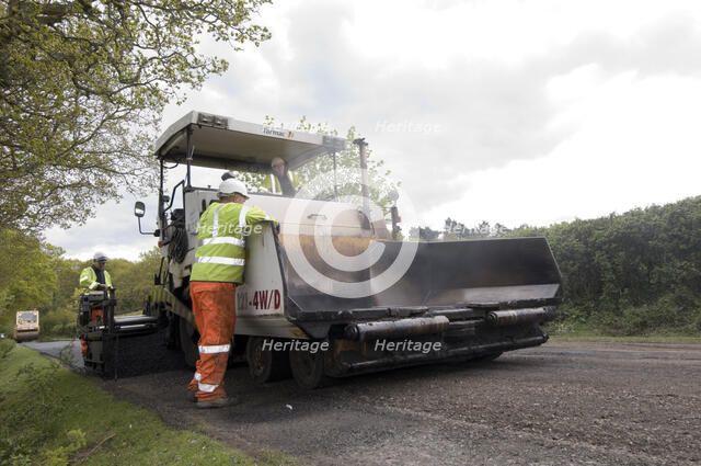 Road resurfacing work repairing potholes Artist: Unknown.