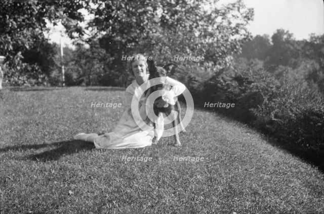 Robins, Miss, with dog, outdoors, 1918 Feb. 16. Creator: Arnold Genthe.
