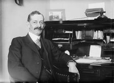 Robt. N. Page seated at desk, 1916. Creator: Bain News Service