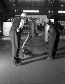 Rolling steel bars, Park Gate Iron & Steel Co, Rotherham, South Yorkshire, 1964. Creator: Michael Walters