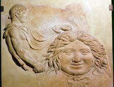 Roman fragment of a terracotta Campana relief showing head of Medusa with figure of Perseus