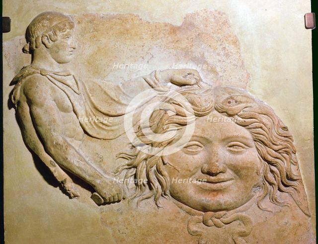 Roman fragment of a terracotta Campana relief showing head of Medusa with figure of Perseus. Artist: Unknown