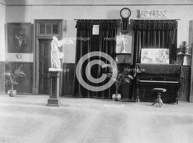Room with piano, potted palms, and classical statues and friezes, (1899?). Creator: Frances Benjamin Johnston.