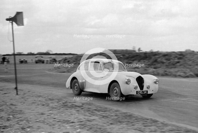 Ray Playford driving a Healey Elliott, at Snetterton Circuit, Norfolk, 1953. Creator: Unknown.