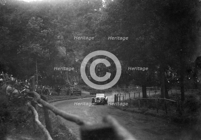Raymond Mays' 4500 cc Invicta competing in the Shelsley Walsh Speed Hill Climb, Worcestershire. Artist: Bill Brunell.