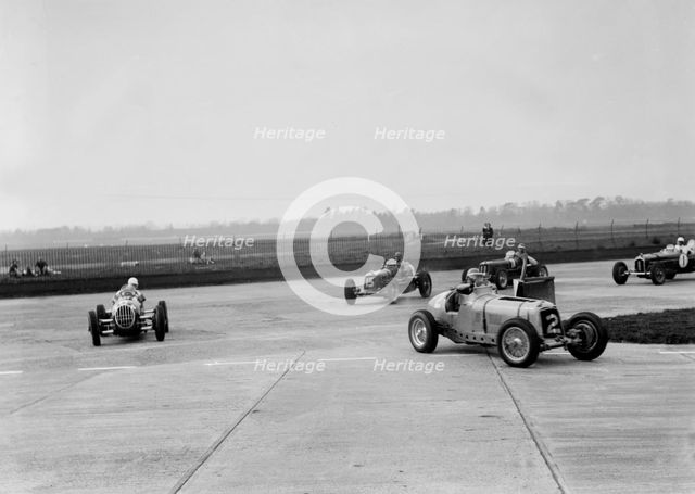 Racing cars taking a corner at Brooklands, Surrey, c1930s. Artist: Bill Brunell.