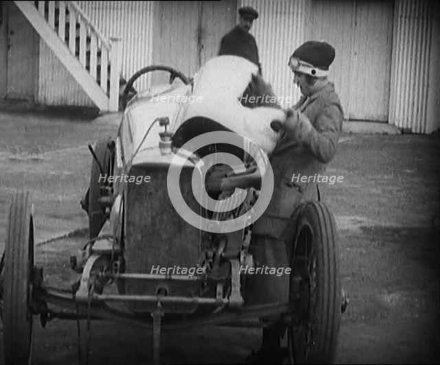 Racing Driver Ivy Cummins Wearing a Racing Outfit Opening a Bonnet of Her Car, 1920. Creator: British Pathe Ltd.