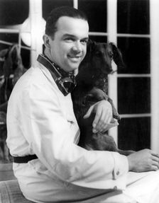 Racing driver Rudolph Caracciola with his pet dog. Creator: Unknown