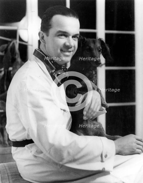 Racing driver Rudolph Caracciola with his pet dog. Creator: Unknown.