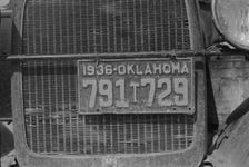 Radiator and license of Oklahoma cotton picker's car, San Joaquin Valley, California, 1936. Creator: Dorothea Lange
