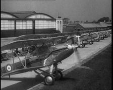 RAF Biplanes Taxiing Across a Field at tended to by Their Aircrews, 1933. Creator: British Pathe Ltd
