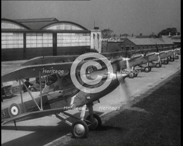 RAF Biplanes Taxiing Across a Field at tended to by Their Aircrews, 1933. Creator: British Pathe Ltd.