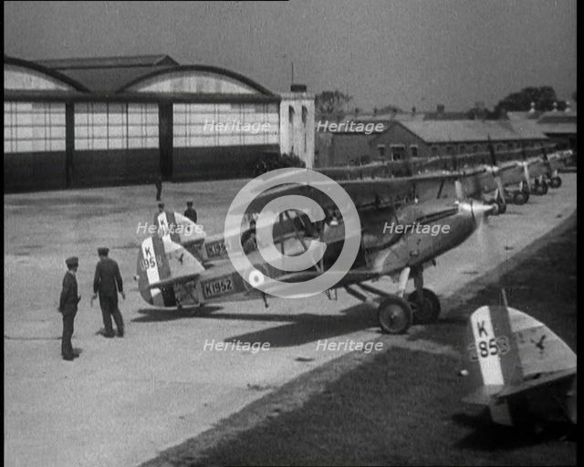 RAF Biplanes Taxiing Across a Field at tended to by Their Aircrews, 1933. Creator: British Pathe Ltd.