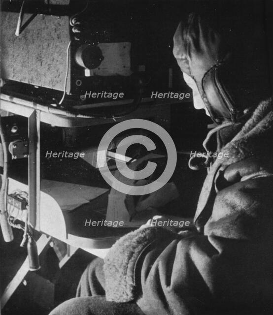 RAF Coastal Command radio operator on board his aircraft, c1940 (1943). Artist: Unknown.