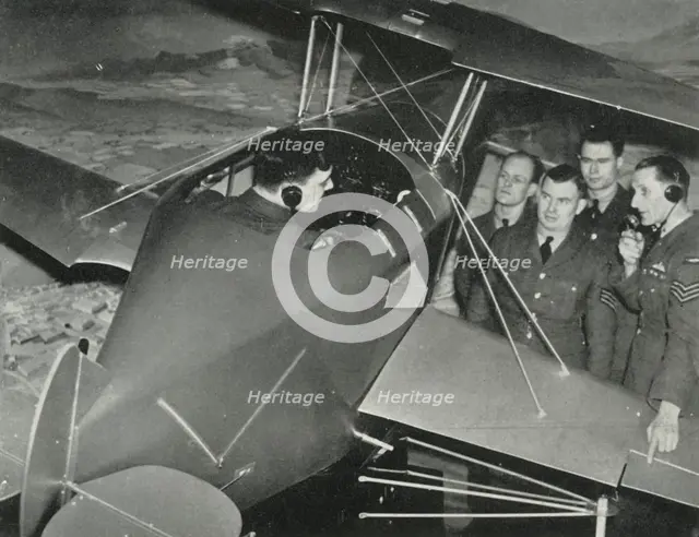 RAF personnel learning to fly in a flight simulator during the Second World War, 1941. Creator: Charles Brown.