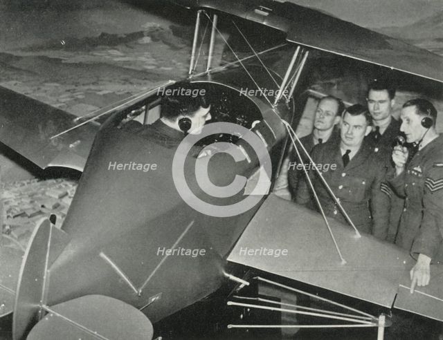 RAF personnel learning to fly in a flight simulator during the Second World War, 1941. Creator: Charles Brown.