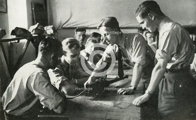 RAF personnel learning about weapons, 1941. Creator: Charles Brown.