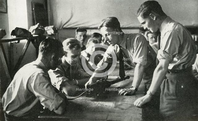 RAF personnel learning about weapons, 1941. Creator: Charles Brown.