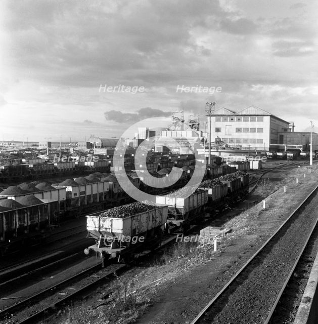 Rail trucks loaded with coal leaving Lynemouth Colliery, Northumberland, 1963.  Creator: Michael Walters.