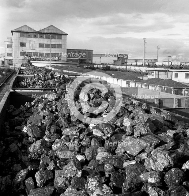 Rail trucks loaded with coal leaving Lynemouth Colliery, Northumberland, 1963.  Creator: Michael Walters.