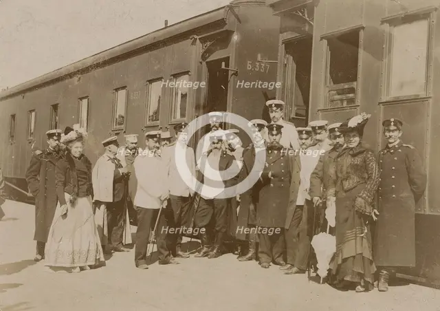Railway employees against the background of train cars, 1910-1919. Creator: Unknown.