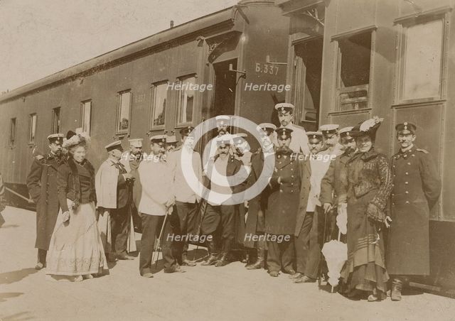 Railway employees against the background of train cars, 1910-1919. Creator: Unknown.