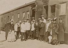 Railway employees against the background of train cars, 1910-1919. Creator: Unknown
