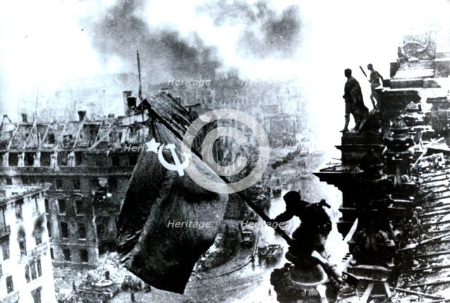 Raising a flag over the Reichstag, 2 May 1945. Creator: Yevgeny Khaldei.