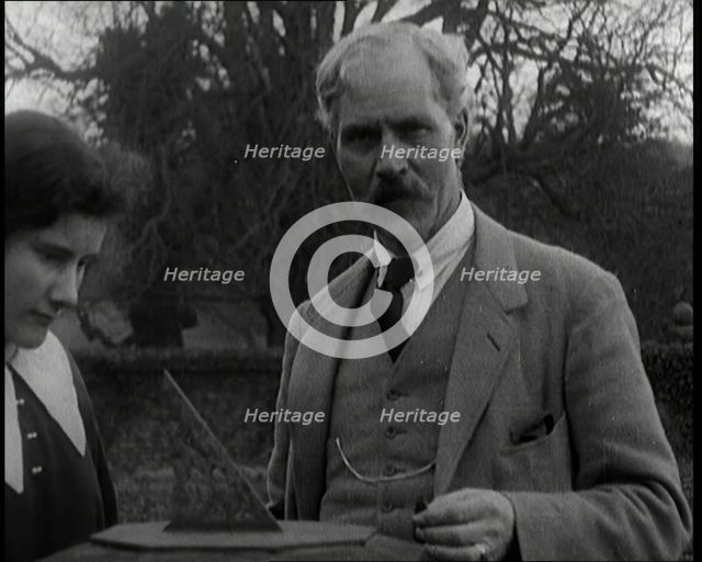 Ramsay MacDonald and His Daughter Ishbel Allan MacDonald Standing Beside a Sundial in a Garden,1920s Creator: British Pathe Ltd.