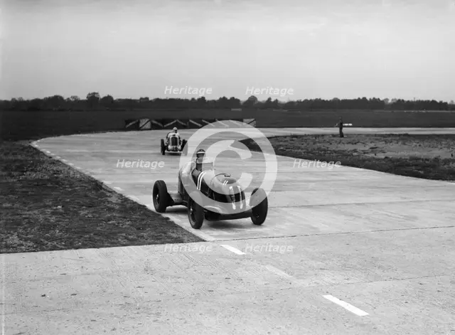 Rapier Special Racing single seater leading a MG in a race on the Campbell Circuit at Brooklands. Artist: Bill Brunell.